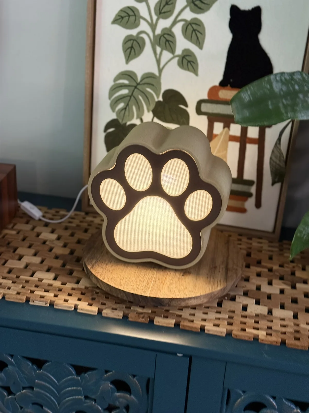 Anonymous custom print job example showing a close view of a lit 3D printed paw-shaped lamp.