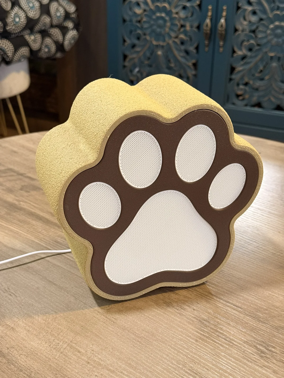 Anonymous custom print job example showing the front of a 3D printed paw-shaped lamp.