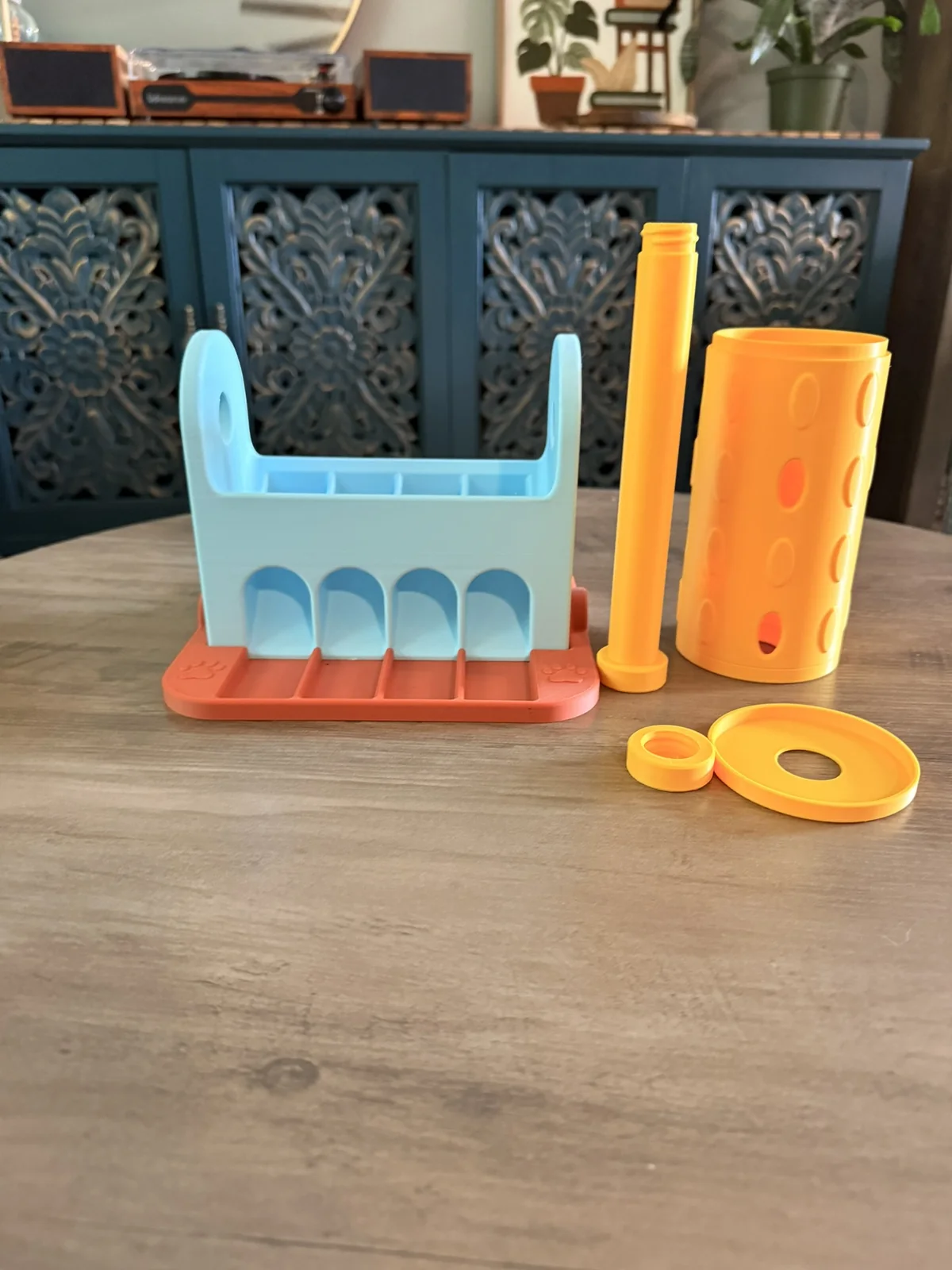 Anonymous custom print job example showing 3D printed spinning treat roller components before final assembly.