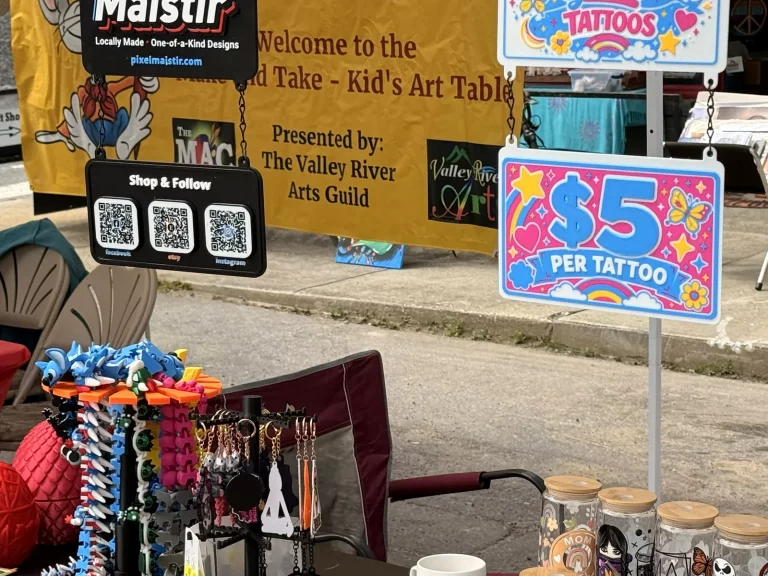 Faerie Dust and Treasure Company glitter tattoo sign at Murphy Spring Festival 2026.