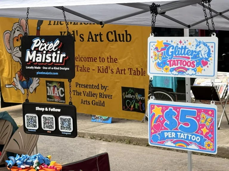 PixelMaistir and Faerie Dust shared vendor booth signage at Murphy Spring Festival 2026.