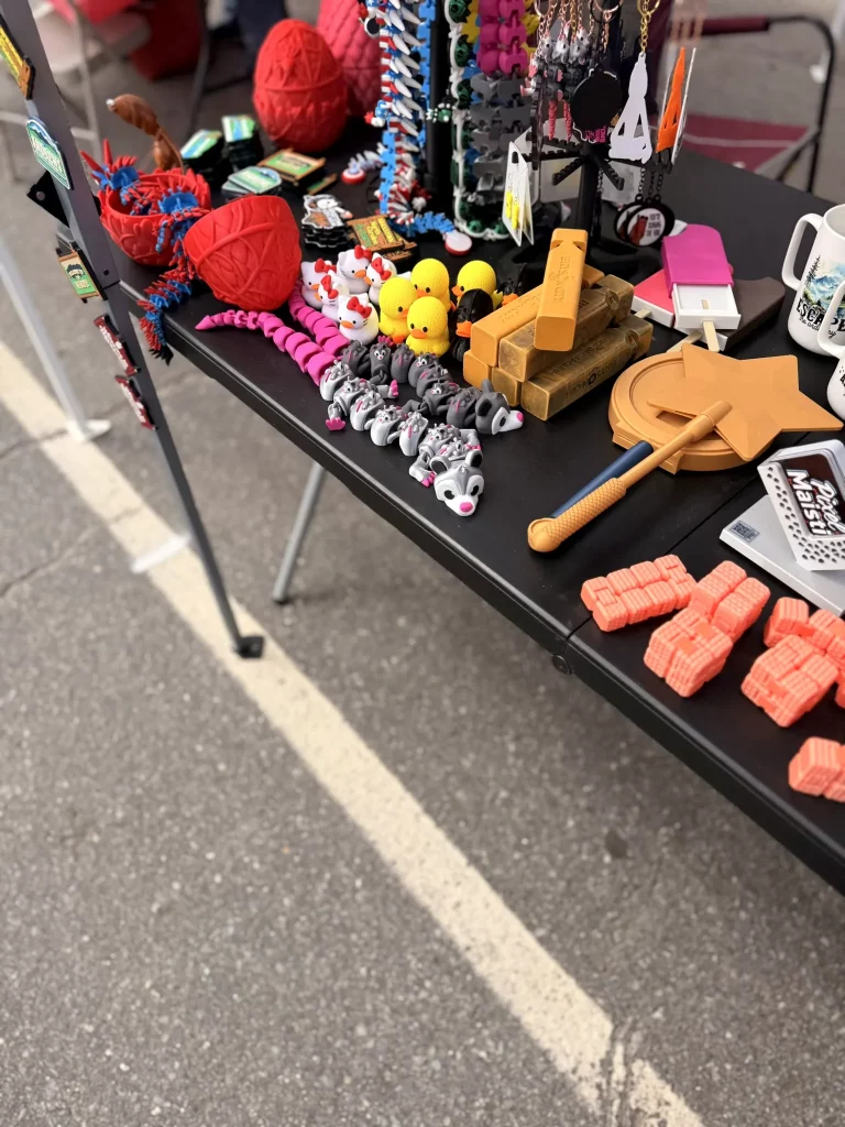 3D printed gifts and colorful display pieces by PixelMaistir at Murphy Spring Festival 2026.